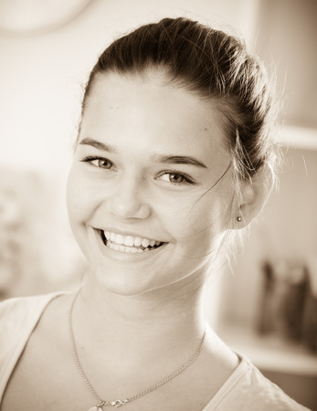 closeup portrait of excited young girl standing indoorsの写真素材