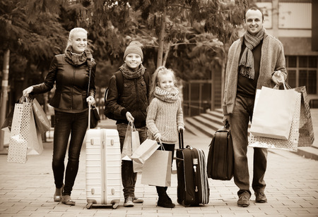 Smiling parents with school age children enjoying shopping tourの写真素材