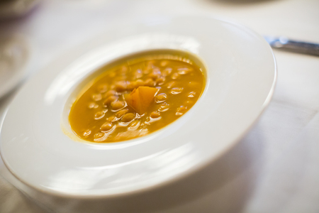 chick pea soup on a white plate, close up shotの写真素材
