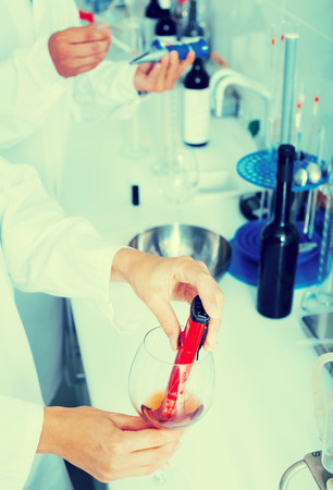 Close up on hands testing quality in chemical labの写真素材
