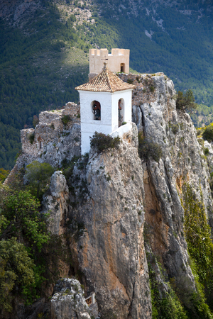 Old building of Guadalest castle surrounded by forest and mountainsのeditorial素材