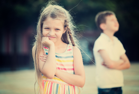 sad girl in preschool age having problem with friend outdoors in parkの写真素材