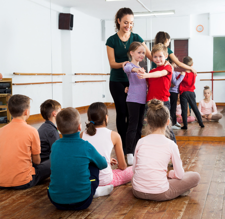 Beautiful children studying modern style dance in class and their teacherの写真素材