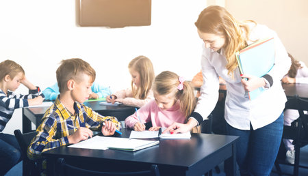 Little children with their teacher at a classroom in school