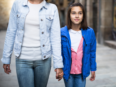 Woman and girl walking in city during sightseeing tourの写真素材