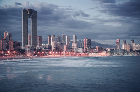 night illumination of Benidorm town with modern housing and coastlineの写真素材