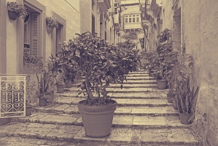 Old narrow  street of european town (Vittoriosa, Malta)の写真素材