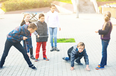 Boy gently passes through the tangled ropeの写真素材