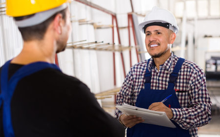 Middle age controller offering contract to engineer at workshop