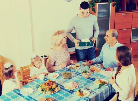 happy family celebrating birthday at festive dinner todayの写真素材