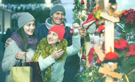 Portrait of happy european family couple with teen girl at  Christmas fairの写真素材