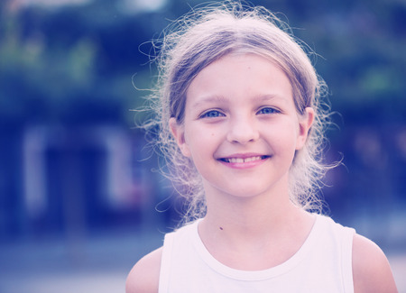 portrait of smiling girl standing outdoors on summer dayの写真素材