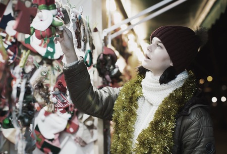 Female customer near counter with Christmas giftsの写真素材