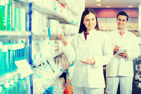 Portrait of two smiling friendly pharmacists working in luxury pharmacyの写真素材