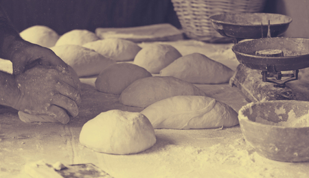 Preparing dough for baking in small bakehouseの写真素材