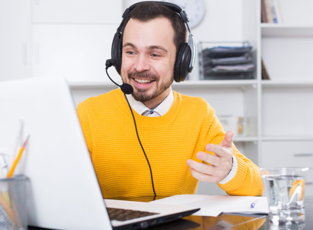 Male student having a productive day at online courses at home