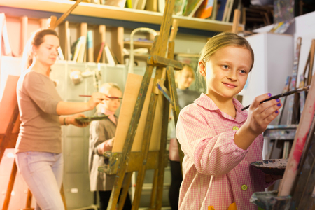 Smiling student to practice drawing in a studioの写真素材