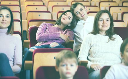 Teenage couple enjoying film at date in cinema houseの写真素材