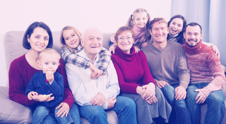 Ordinary family making numerous photos during family dinner. Focus on elderly manの写真素材