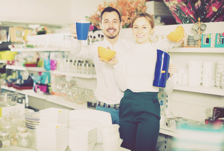 Young spouses show their purchases at a ceramics shopの写真素材
