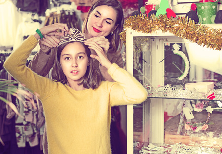 Adult with teenage-girl are acquiring fashionable accessories in childrens clothing store.の写真素材
