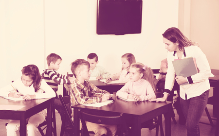 Professor and elementary age children in a classroomの写真素材