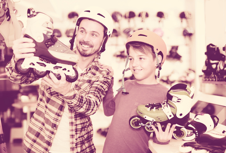 Sportsmen are looking for white roller-skates in the sports shop.の写真素材