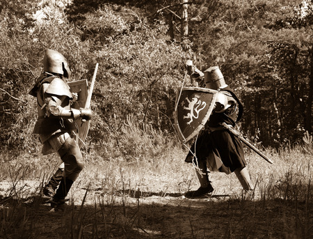 Two knights in armor is fighting  at forestの写真素材