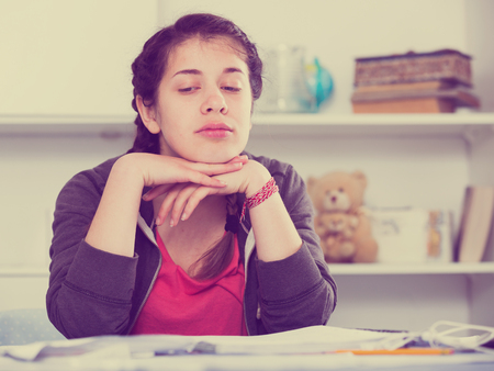 Young teenage girl having problems and depression at homeの写真素材