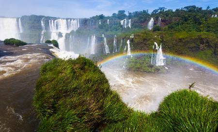 Rainbow over streams of waterfall Cataratas del Iguazu in Iguazu National Park, Brazilの写真素材