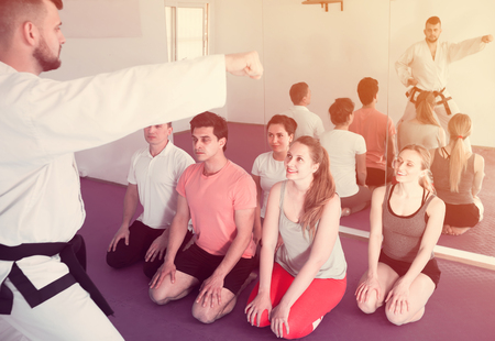 Karate teacher demonstrates techniques of receptions  for apprentices in the indoorsの写真素材