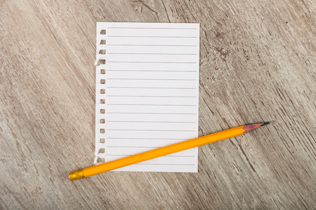 Torn sheet of notebook with pencilの写真素材