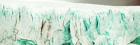 Panorama of rugged glacier cracked edge Perito Moreno (Glaciar Perito Moreno) on sunny summer day....