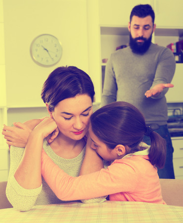 Young father correcting his wife and child for disobedience at homeの写真素材