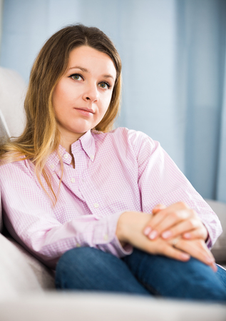 Young female feeling and spending day alone at homeの写真素材