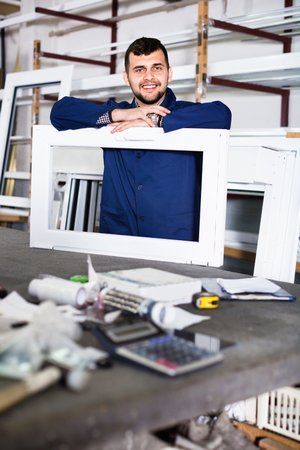 Efficient professional  labour with finished PVC profiles and windows at factoryの写真素材