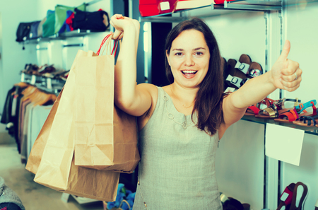 Portrait of smiling female in footgear storeの写真素材