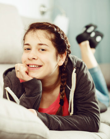 Young girl posing playfully in good humor in free timeの写真素材