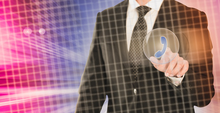 Man in business suit using call button on virtual interfaceの写真素材