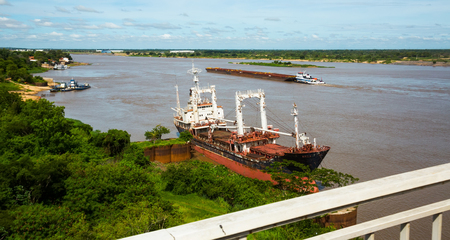 View on brown water of the Paraguay River with Asuncion in distanceの写真素材
