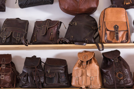 Handmade leather backpacks and bags on shelf in spain shop