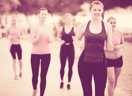 Happy young girls during racewalking training in daytimeの写真素材