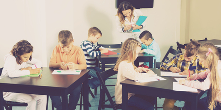 Little children with professional teacher drawing in classroom on the lessonの写真素材
