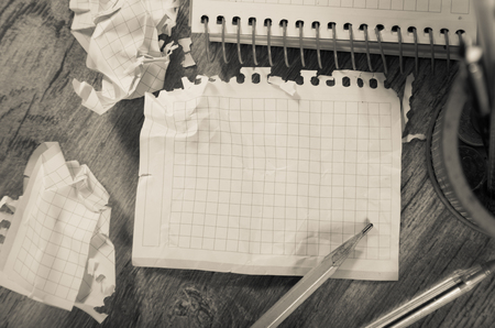 Empty crumpled pages from notebook lying on wooden surfaceの写真素材