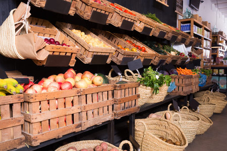 many different fresh fruits and vegetables in baskets on food market