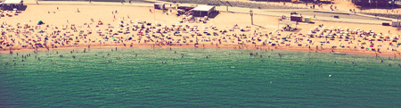 Beach with many people resting at Barcelona seaside in  Spainの写真素材