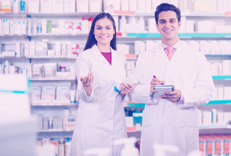 Young european team of pharmaceutist and technician working in chemist shopの写真素材