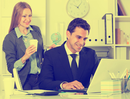 Focused business team working with computer in modern officeの写真素材