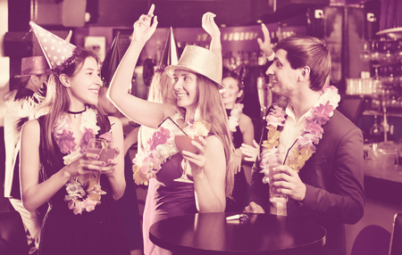 Young friends dancing on the birthday party with the cocktailsの写真素材