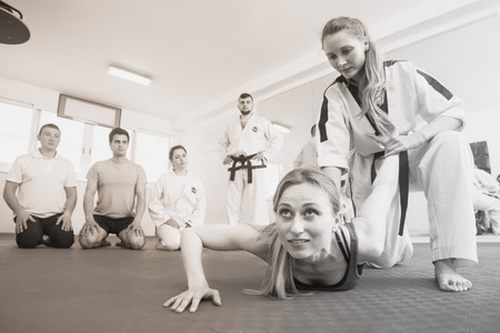 Young girl in a taekwondo training teaches new tricks of defenseの写真素材
